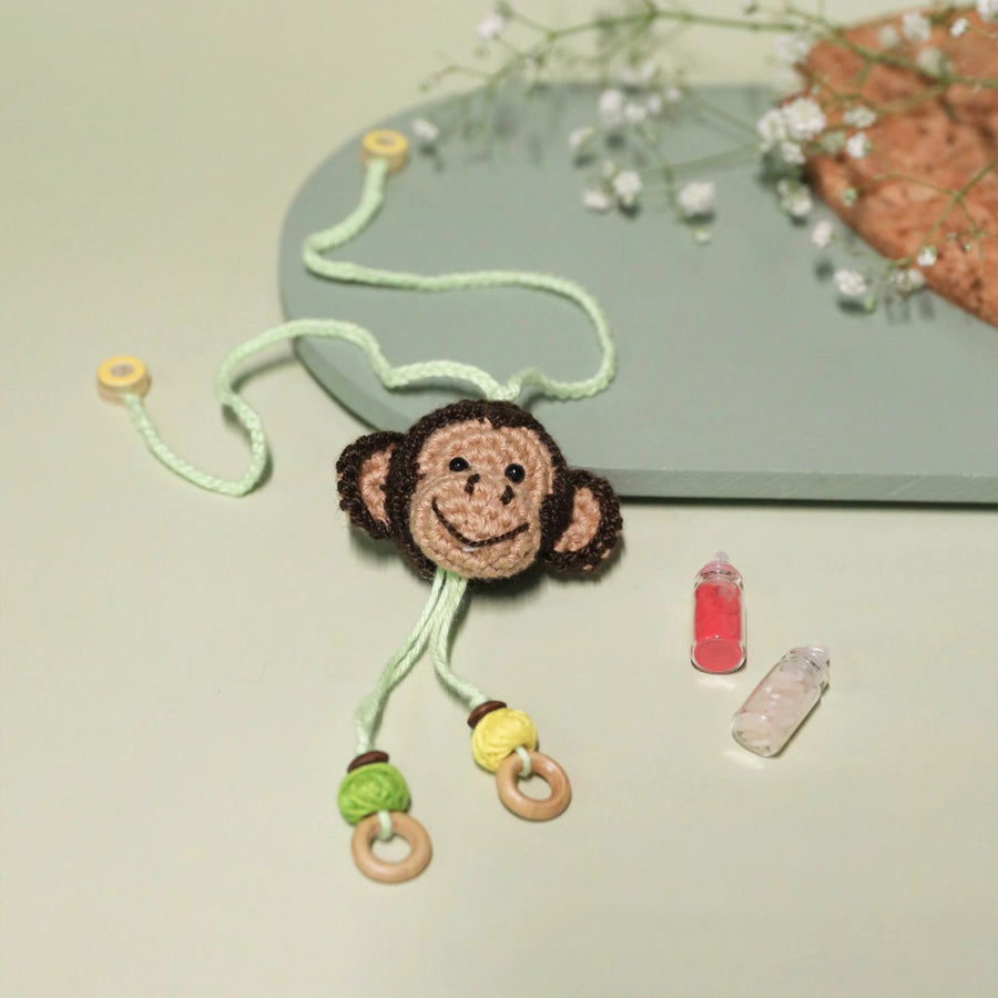 Handmade Crochet Playful Monkey Kids Lumba Rakhi For Girls With Roli Chawal - Flat Lay Display