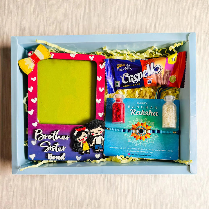 Photo Personalized Brother Sister Bond Mdf Wood Rakhi Hamper With Chocolates And Roli Chawal Includes 1 Fridge Magnet 1 Rakhi - Flat Lay Product Arrangement
