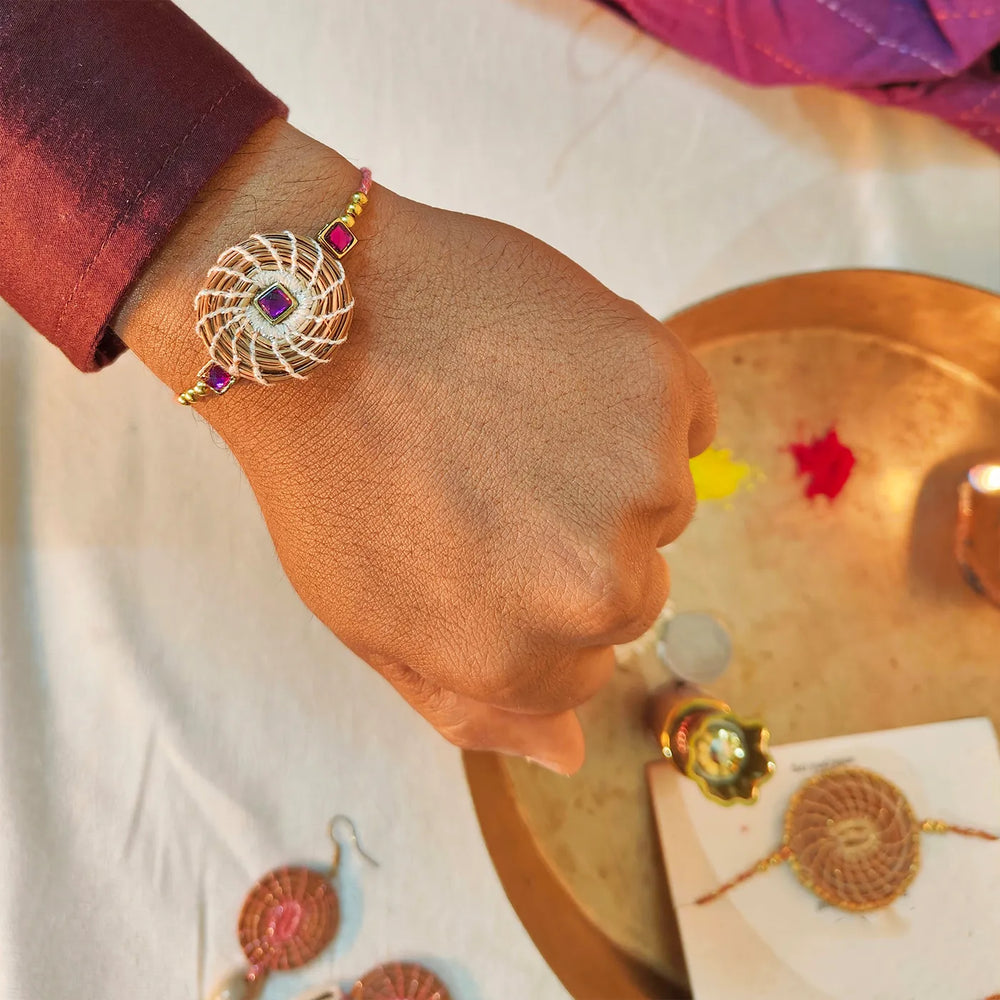 Eco Friendly Handmade Purple Stone Pine Needle Rakhi With Pouch And Roli Chawal - Worn on wrist display