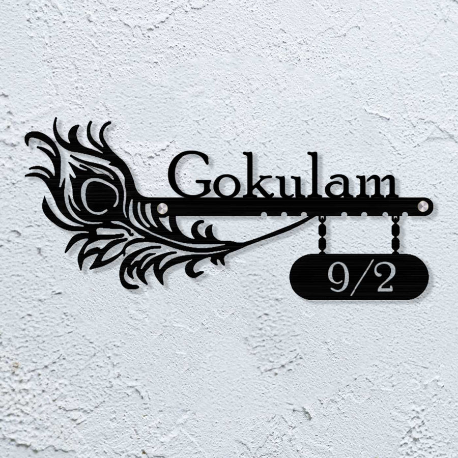 Personalized Laser Cut Peacock Feather Theme Steel Name Plate 10 - Mounted on Textured Wall Close-up