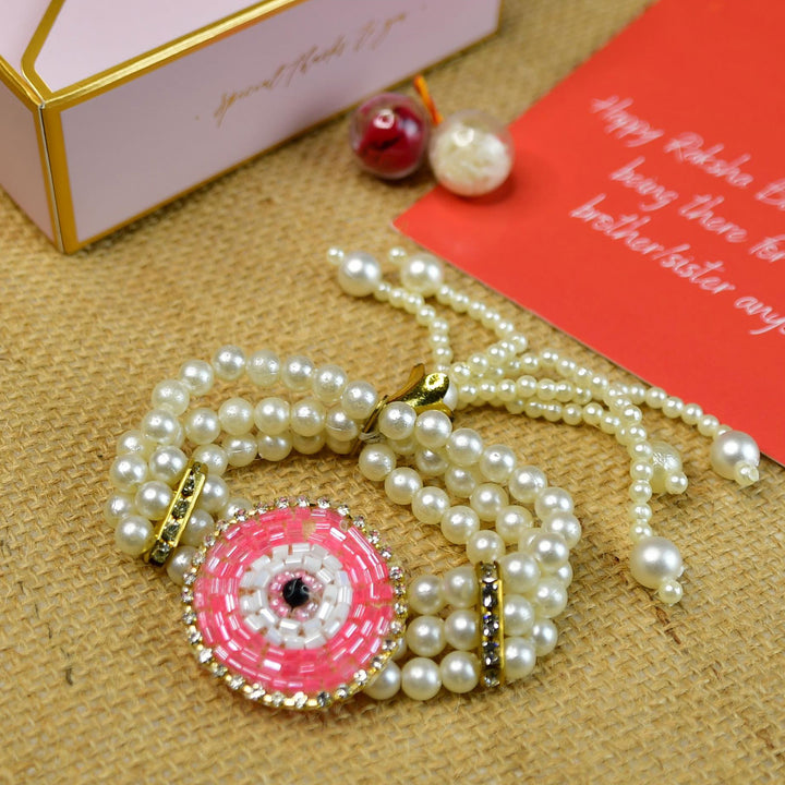 Beaded Pink Round Pearl And Stone Rakhi Hamper With Chocolates And Roli Chawal For Bhaiya And Bhabhi Customizable Options Includes Up To 7 Goodies - Close-up of beaded bracelet detail