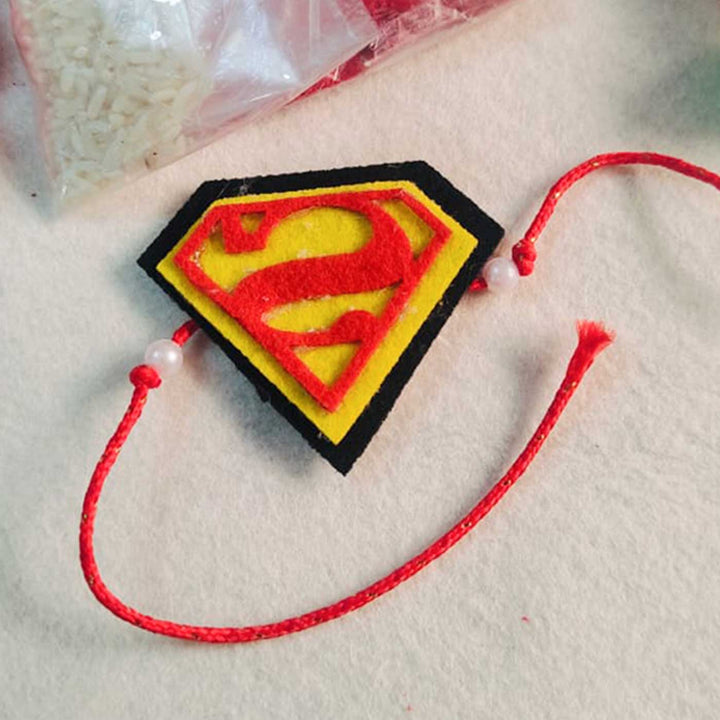 Handmade Beaded Superman Theme Pom Pom Felt Rakhi With Roli Chawal For Kids - Close-up Top View