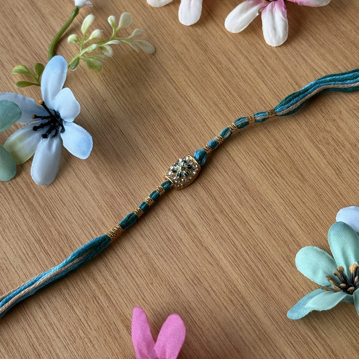 Handmade Stone Embedded Flower Rakhi With Roli Chawal - Single Bracelet Close-up Blue
