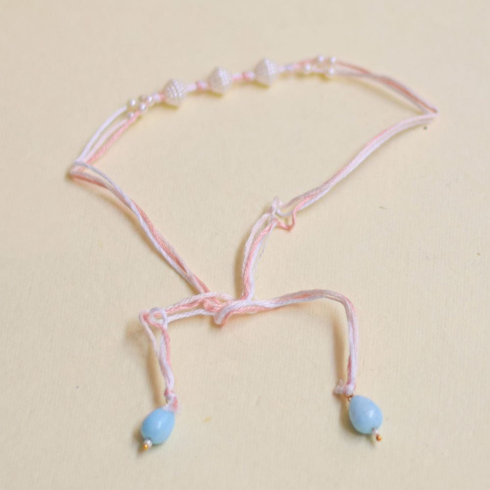 Handmade Trimurty Pearl Rakhi With Roli Chawal - Pink bracelet with bead ends