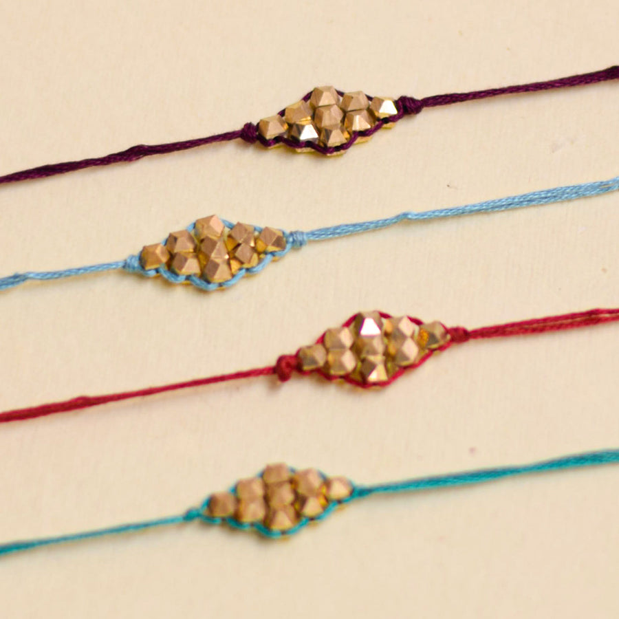 Handmade Sunehra Bandhan Rakhi With Roli Chawal - Close-up of four bracelets