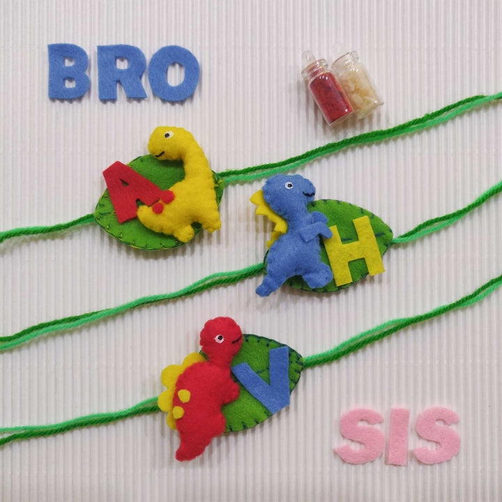 Personalized Handmade Dinosaur Theme Felt Kids Rakhi With Roli Chawal - All three dinosaur wristbands displayed together
