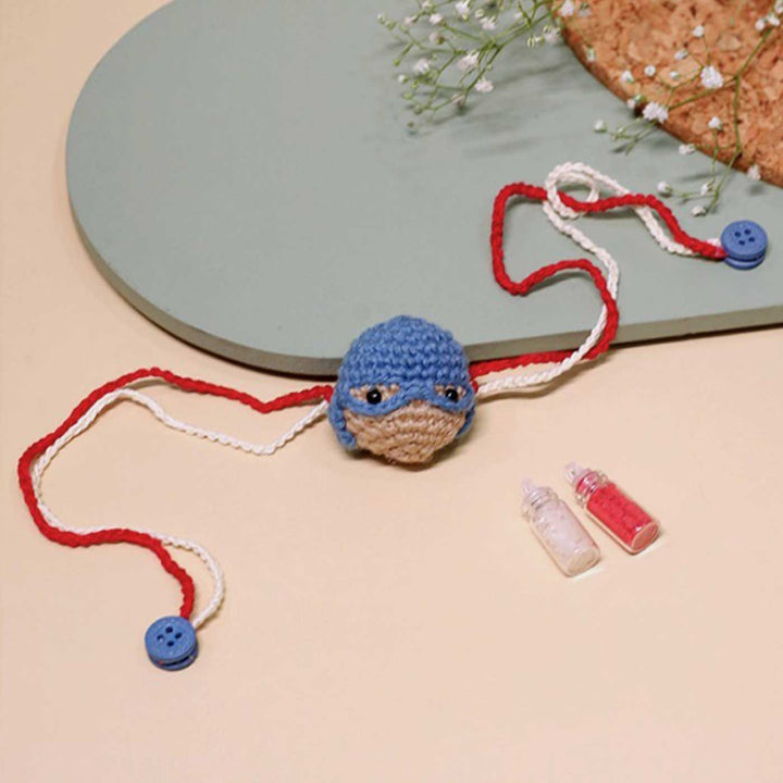 Handmade Crochet Captain America Kids Rakhi With Roli Chawal - Laid Flat with Accessories