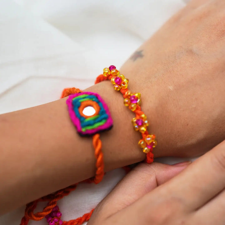 Handmade Embroidered And Beaded Patola Rakhi With Roli Chawal Set Of 3 - Close-up of Wrist Bracelets