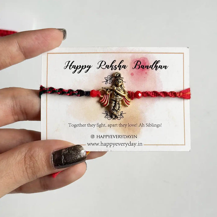 Handmade Krishna Motif Rakhi With Roli Chawal - Bracelet displayed on packaging card