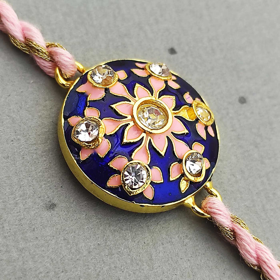 Handmade Meenakari Blue Buta Brass Rakhi With Roli Chawal - Close-up of Rakhi centerpiece