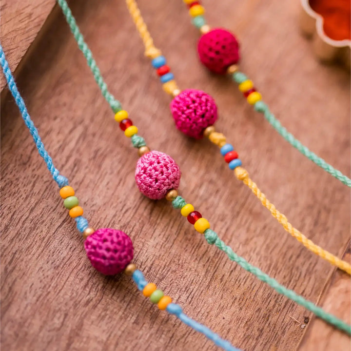 Handmade Crochet Yellow Beads Rakhi With Roli Chawal Set Of 4 - Close-up of purple bead detail