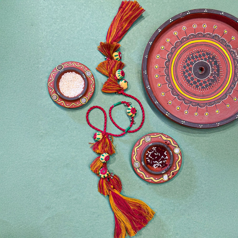 Handmade Reusable Red Potli And Jhumki Rakhi For Bhabhi - Top View with Decor Items