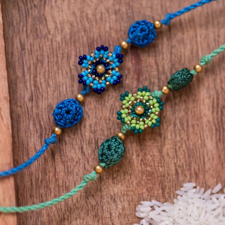 Handmade Crochet Blue And Green Flower Rakhi With Roli Chawal Set Of 2 - Macro Close-up of Beaded Bracelet