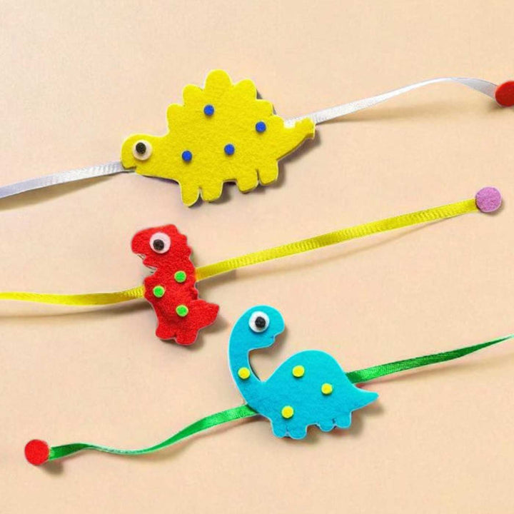Handmade Dinosaur Theme Felt Rakhi Set Of 3 - Close-up of Rakhi Trio
