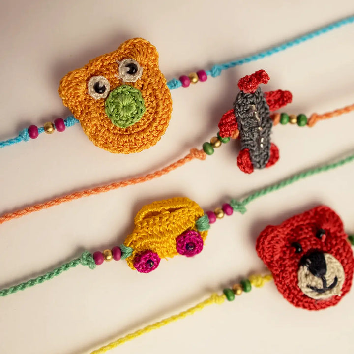 Handmade Crochet Toys And Animals Theme Kids Rakhi With Roli Chawal Set Of 4 - Close-up of Crochet Charms