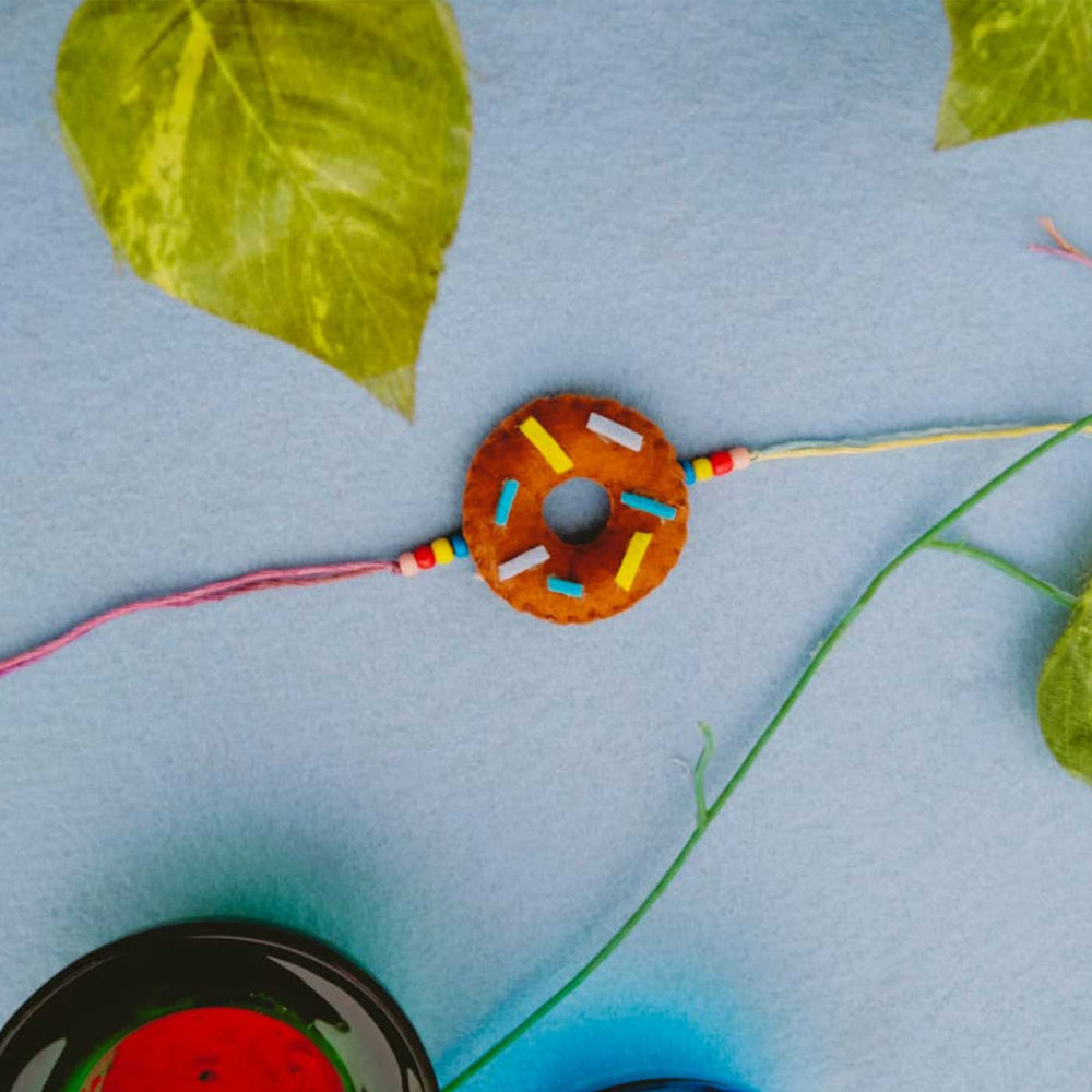 Handmade Doughnut Theme Felt Kids Rakhi - Wide View Showing Bracelet and Surroundings