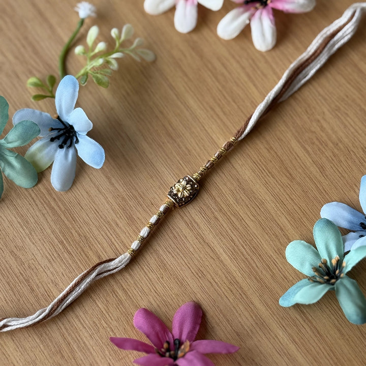 Handmade Stone Embedded Flower Rakhi With Roli Chawal - Single Bracelet Close-up Beige
