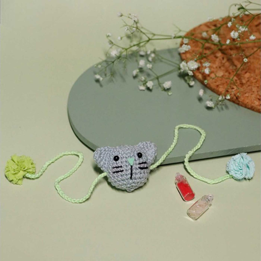 Handmade Crochet Kitty Kisses Kids Rakhi With Roli Chawal - Front View with Styled Background