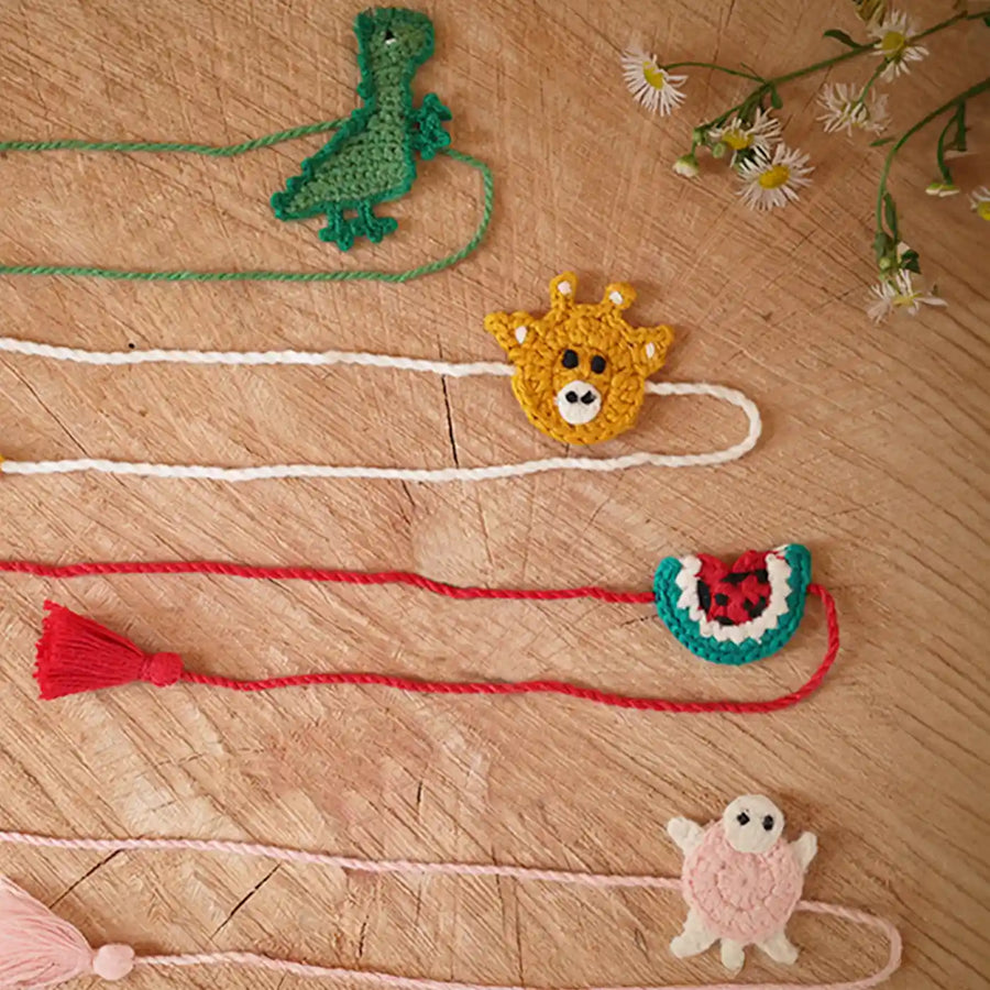 Handmade Crochet Dino Turtle Giraffe And Watermelon Kids Rakhi With Roli Chawal Set Of 4 - Flat Lay with Animal Charms