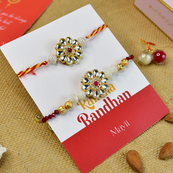 Beaded Floral Pearl And Stone Rakhi Hamper With Chocolates And Roli Chawal For Bhaiya And Bhabhi Customizable Options Includes Up To 7 Goodies - Rakhis on branded card display