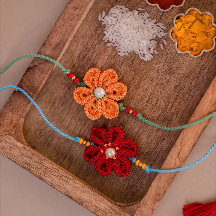 Handmade Crochet Red And Yellow Daffodil Rakhi With Roli Chawal Set Of 2 - Close-up on Floral Thread Detail