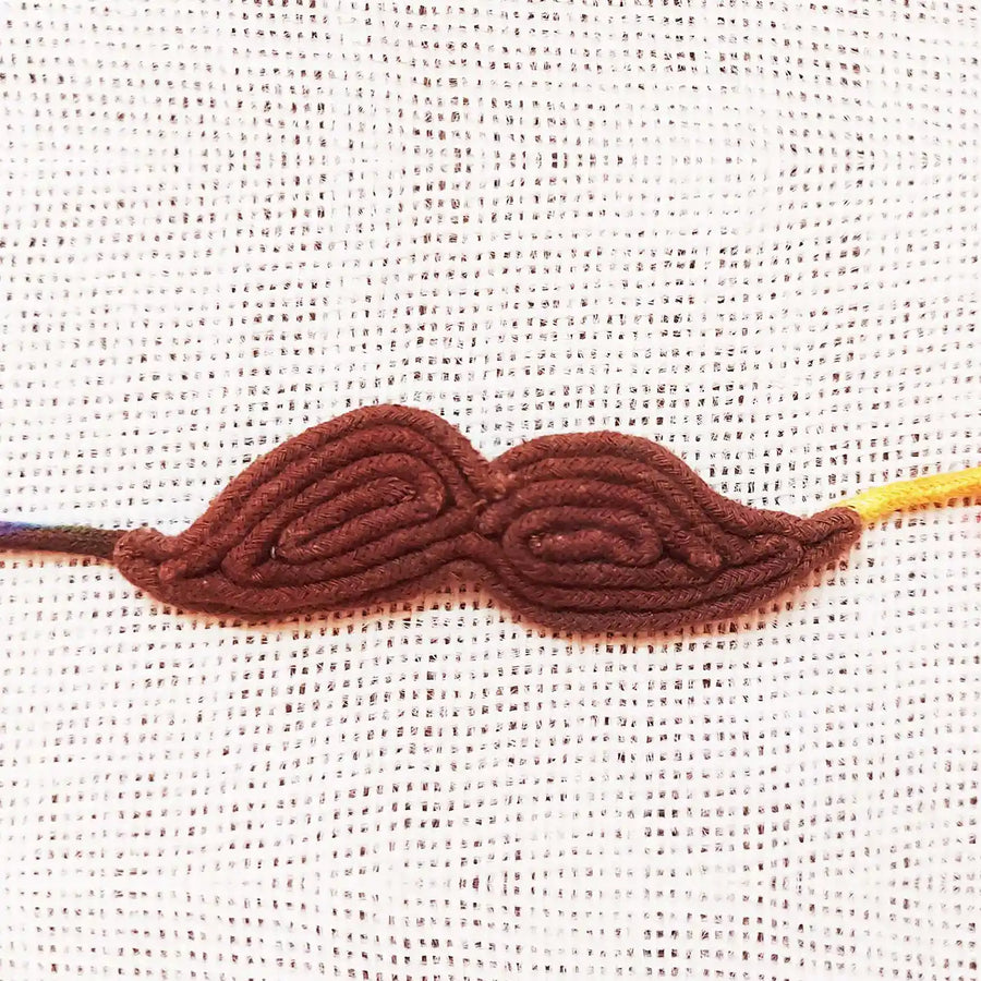 Handmade Dori Work Brown Moustache Rakhi With Roli Chawal - Close-up Front View