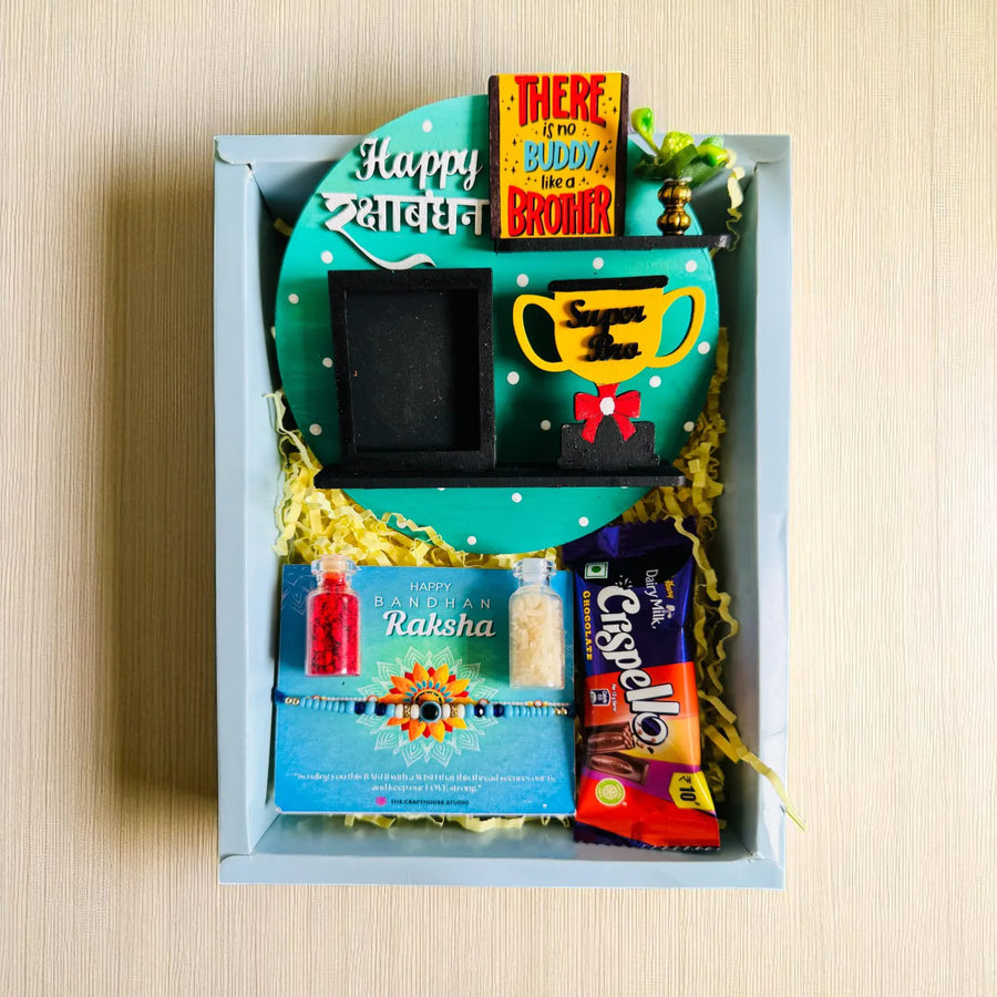 Photo Personalized Super Bro Mdf Wood Rakhi Hamper With Chocolates And Roli Chawal Includes 1 Fridge Magnet 1 Rakhi - Top View of Gift Box Contents