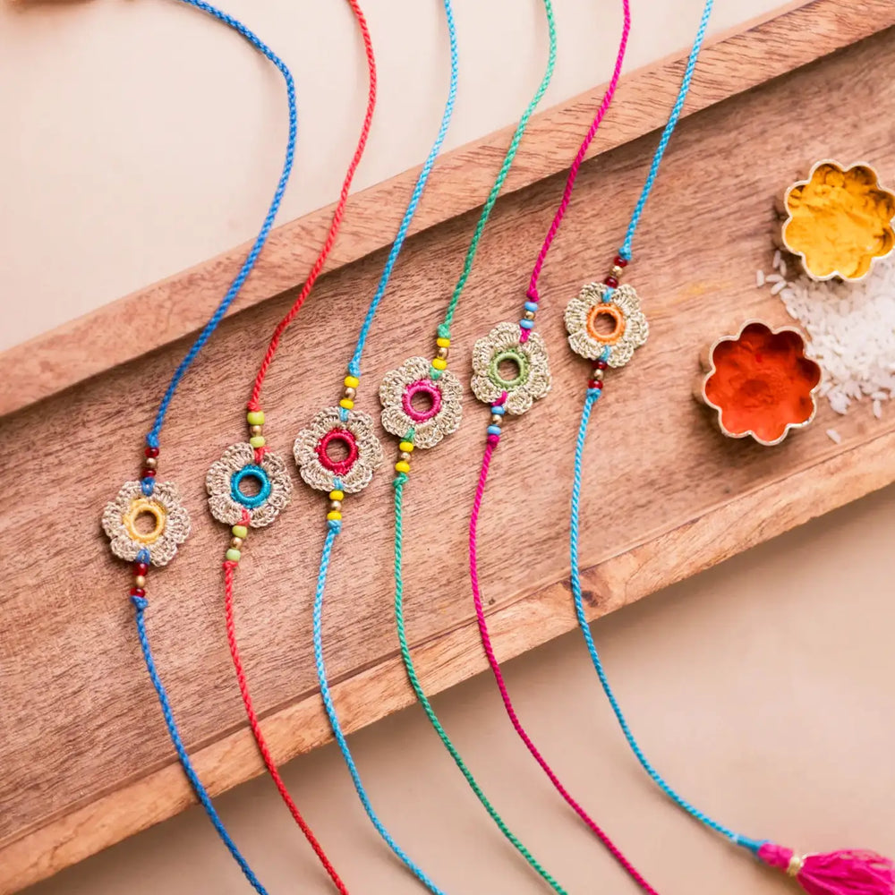 Handmade Crochet Multicolor Golden Flower Rakhi With Roli Chawal Set Of 6 - Top View with Props