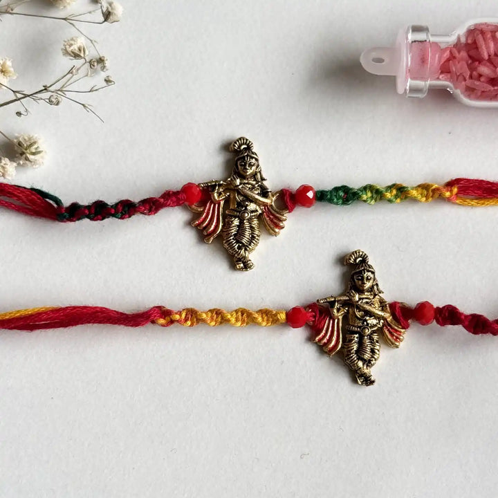 Handmade Krishna Motif Rakhi With Roli Chawal - Close-up of two bracelets