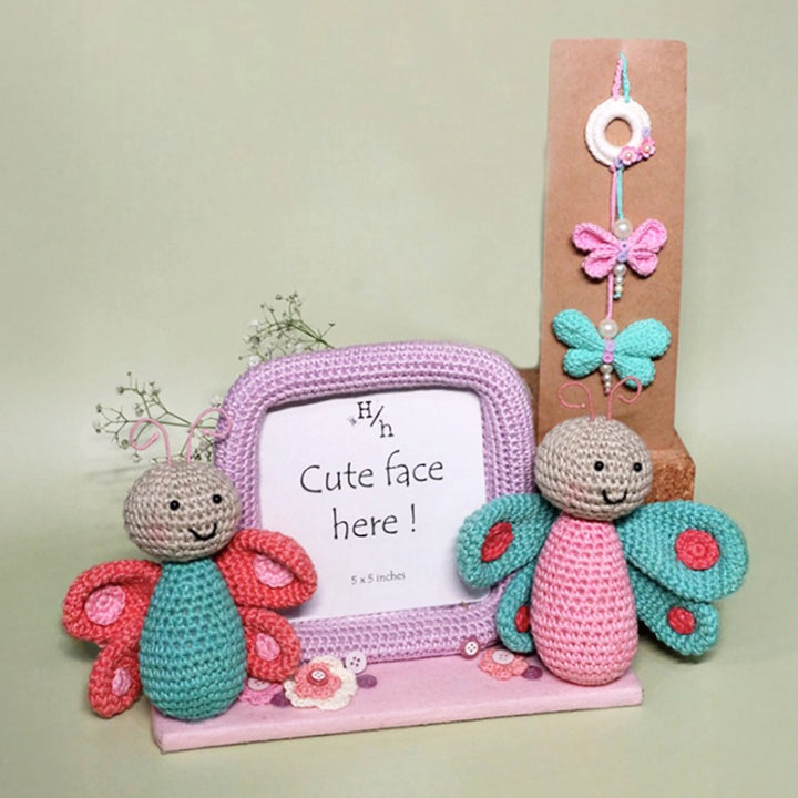 Handmade Crochet Budding Butterflies Kids Lumba Rakhi For Girls With Roli Chawal - Decorative setup with knitted toys and frame