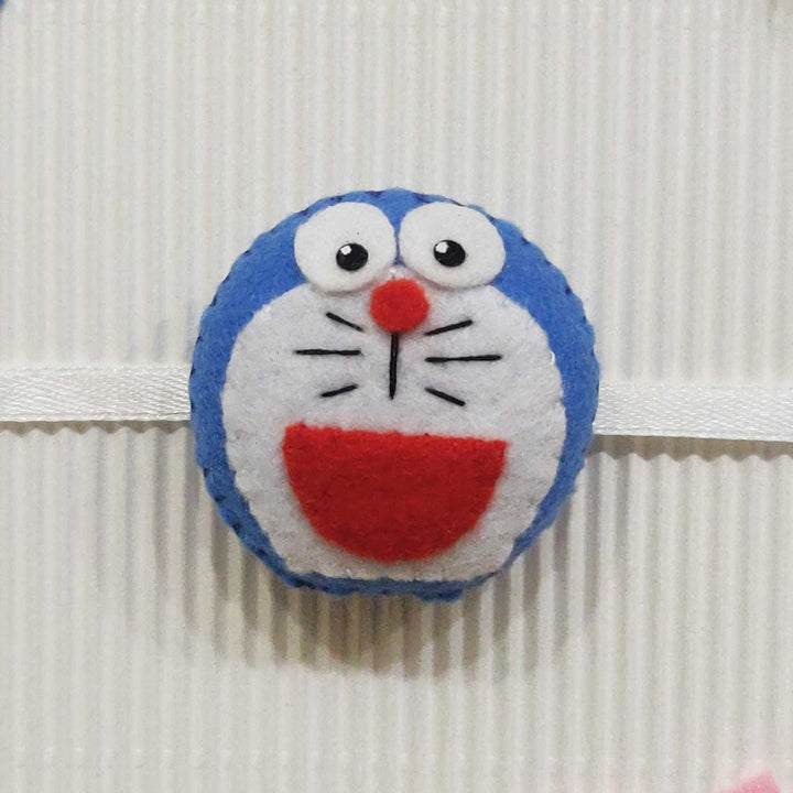 Handmade Doraemon Theme Felt Kids Rakhi With Roli Chawal - Close-up Front View