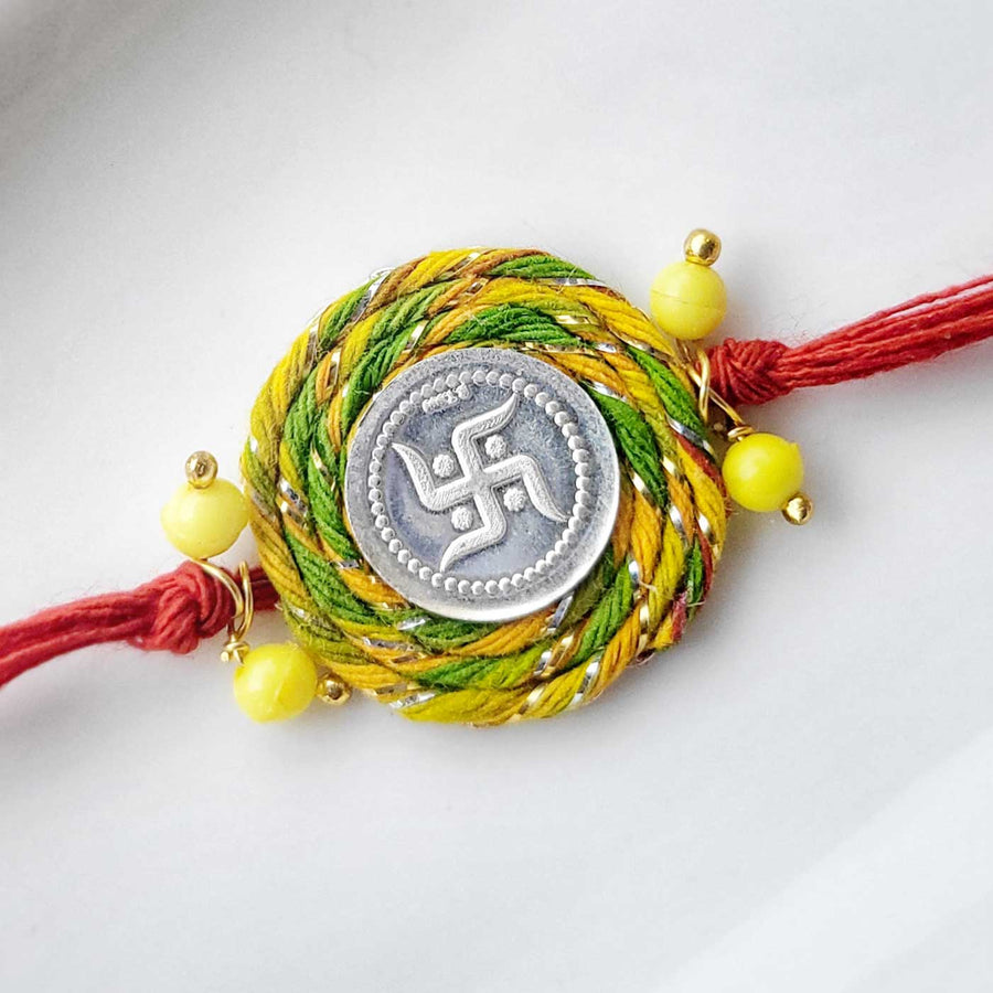 Handmade Swatik Design Silver Rakhi Hamper With Roli Chawal For Brother 1 - Close-up of Rakhi centerpiece