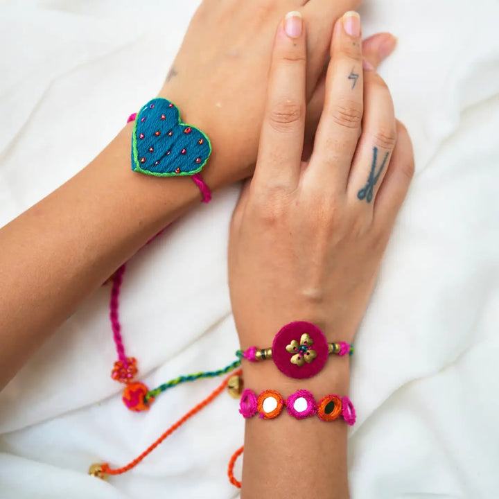 Handmade Mirror Work And Embroidery Only Love Rakhi With Roli Chawal Set Of 3 - Wrist View Showing Two Bracelets