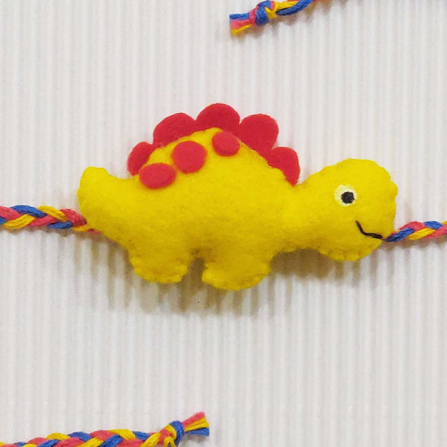 Handmade Dinosaur Theme Felt Kids Rakhi With Roli Chawal - Yellow Dinosaur Close-up Front View