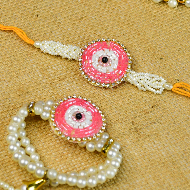 Beaded Pink Round Pearl And Stone Rakhi Hamper With Chocolates And Roli Chawal For Bhaiya And Bhabhi Customizable Options Includes Up To 7 Goodies - Two bracelets laid flat side by side