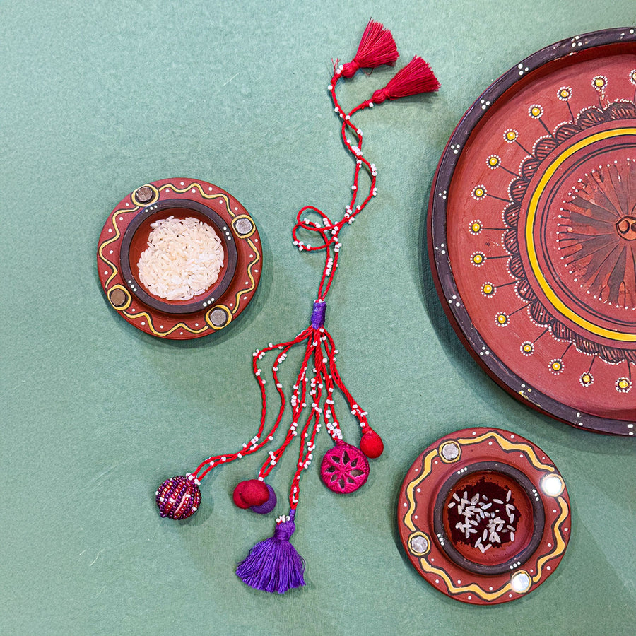 Handmade Reusable Pink Patwa Ari Mirror And Potli Rakhi For Bhabhi - Flat Lay Showing Multiple Items