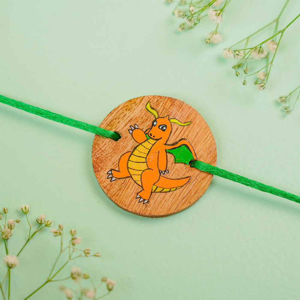 Personalized Hand Painted Dragonite Wooden Rakhi With Roli Chawal - Flat Lay Close-up