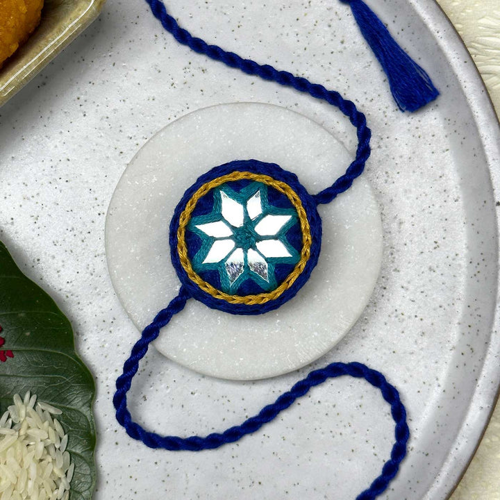 Customized Handmade Mirror Work Cotton Rakhi With Roli Chawal - Styled Front View on Plate (5)