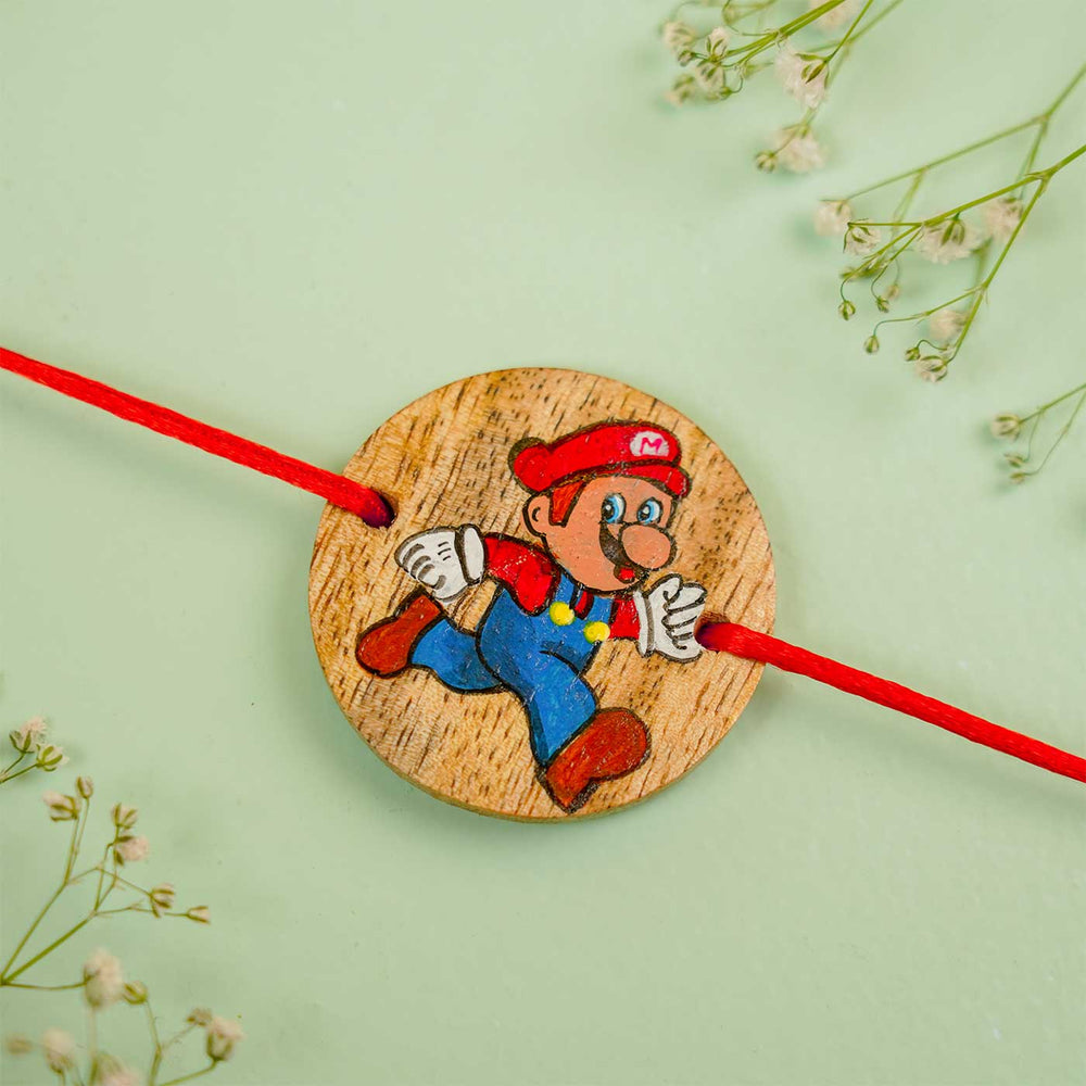 Personalized Hand Painted Mario Wooden Rakhi With Roli Chawal - Close-up with Floral Background