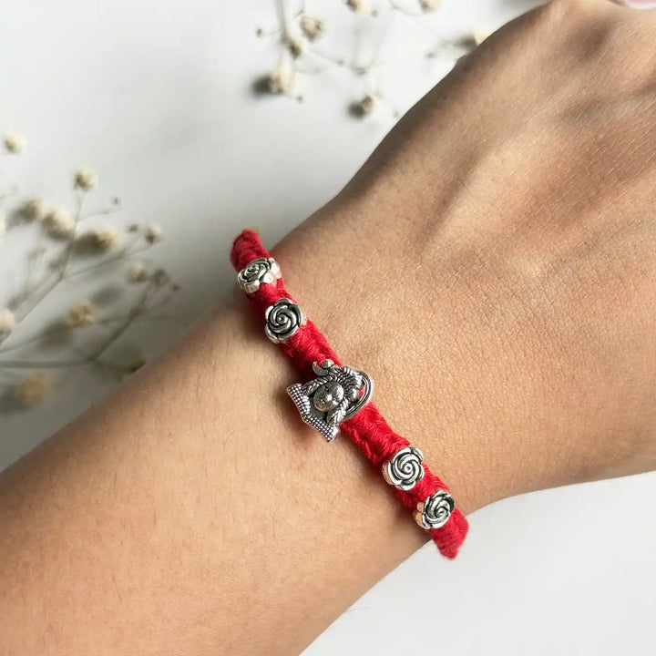 Handmade Shiv Motif Rakhi With Roli Chawal - On Wrist Close-up View