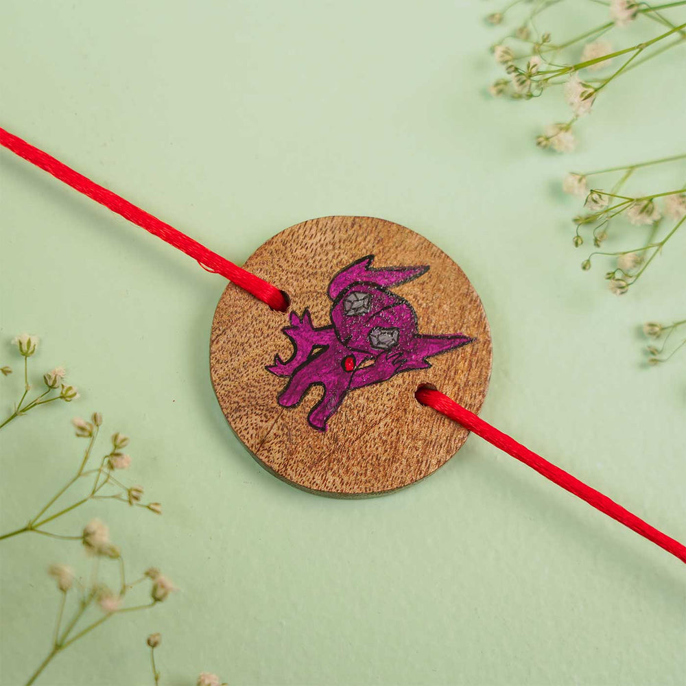 Personalized Hand Painted Sableye Wooden Rakhi With Roli Chawal - Flat Lay Close-up