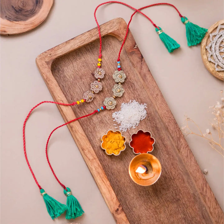 Handmade Crochet Golden Floral Rakhi With Roli Chawal Set Of 2 - Styled Tray Display with Accessories