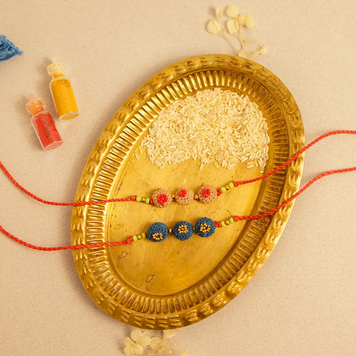 Handmade Crochet Round Ananta Rakhi With Roli Chawal Set Of 2 - Top view with accessories