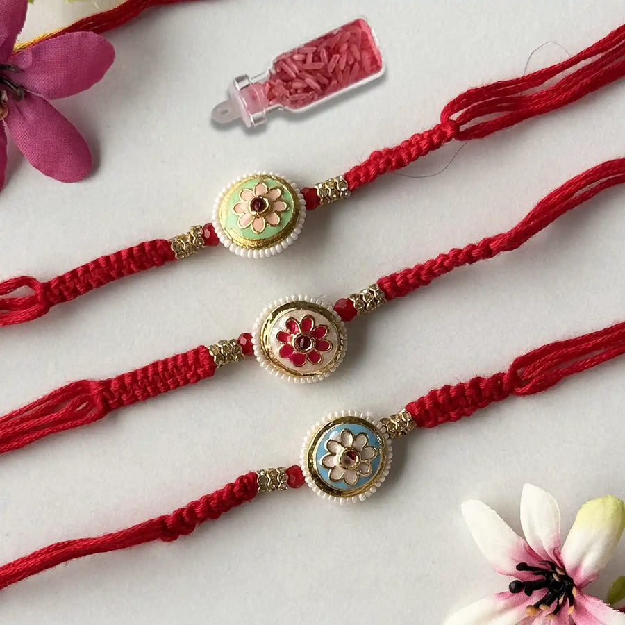 Handmade Elegant Flower Rakhi With Roli Chawal - Three Bracelets Laid Flat
