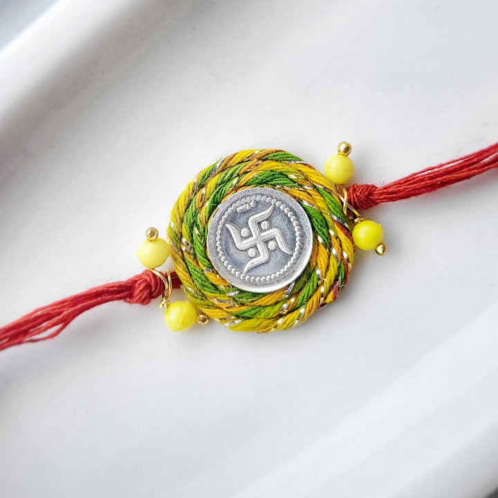 Handmade Beaded Swatik Design Silver Rakhi Hamper With Roli Chawal For Bhaiya And Bhabhi - Close-up of Single Rakhi Thread