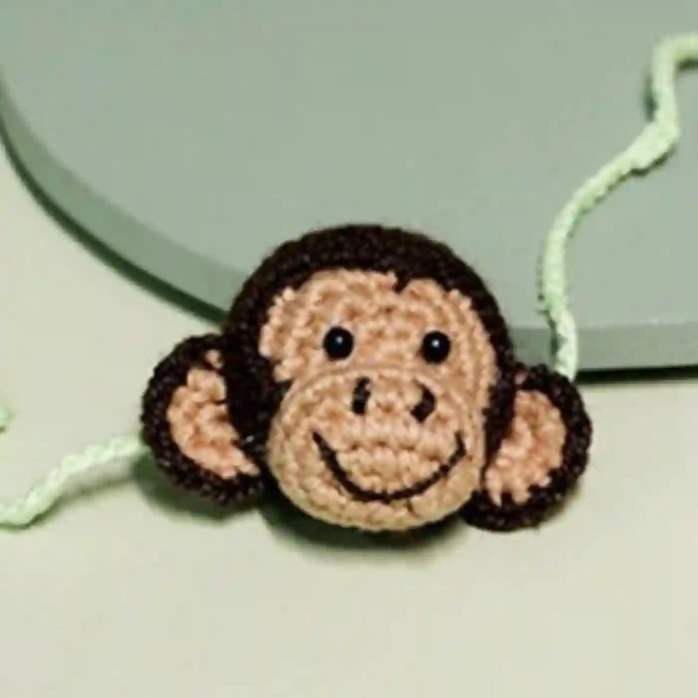 Handmade Crochet Playful Monkey Kids Rakhi With Roli Chawal - Close-up of Crochet Monkey Face
