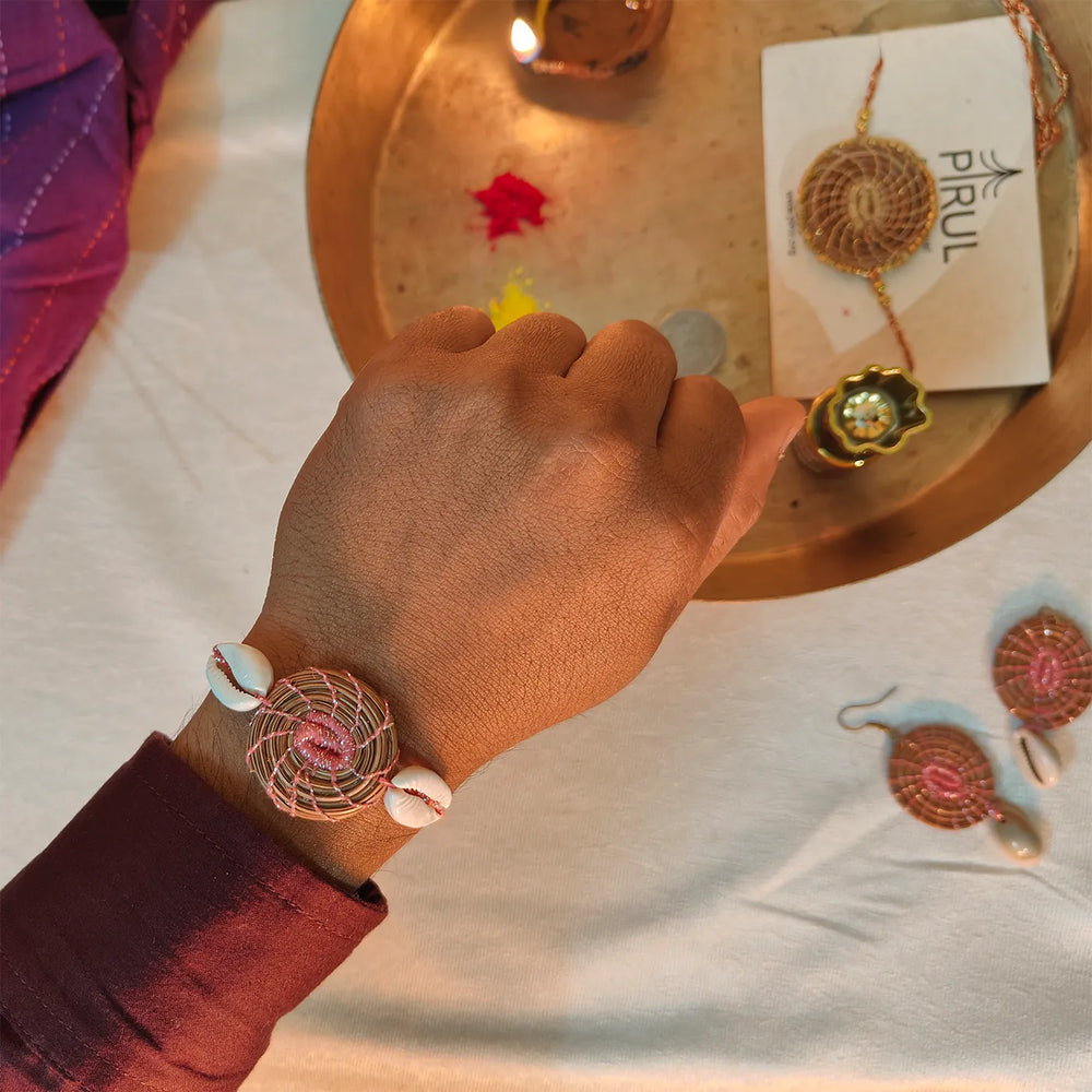 Eco Friendly Handmade Sea Shell Pine Needle Rakhi With Pouch And Roli Chawal - On Wrist Display