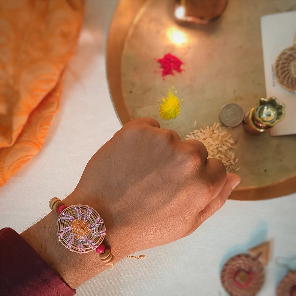 Eco Friendly Handmade Pink And Orange Pine Needle Rakhi With Pouch And Roli Chawal - Worn on wrist