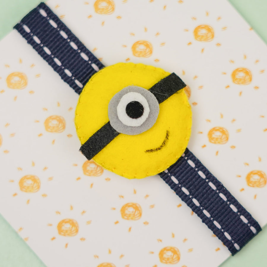 Handmade Minion Theme Felt Kids Rakhi With Roli Chawal - Close-up of wristband charm