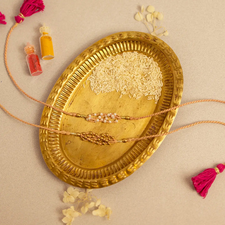 Handmade Crochet Noori Moti Rakhi With Roli Chawal Set Of 2 - Flat lay with paired beads
